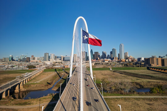 Margaret Hunt Hill Bridge with Texas flag and Dallas skyline
