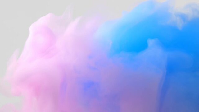 Pink and blue smoke drifting in wispy plumes against a white backgroun