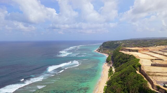 Aerial View of Gunung Payung Beach in Bali, Turquoise Ocean and Limestone Cliffs