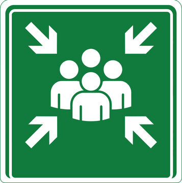 Green emergency assembly point sign with white human icons and directional arrows on square background