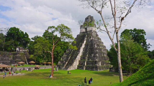 Temple of the Great Jaguar rising above plaza with visitors, Tikal