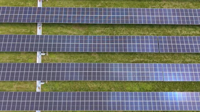 Large scale solar power installation with panel parallel line. Aerial top-down view