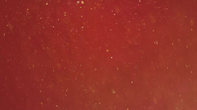 Bokeh leak twirl. Flare glimmer. Red orange whirl mixing flow. Bright shimmering light color particles spill abstract art background.