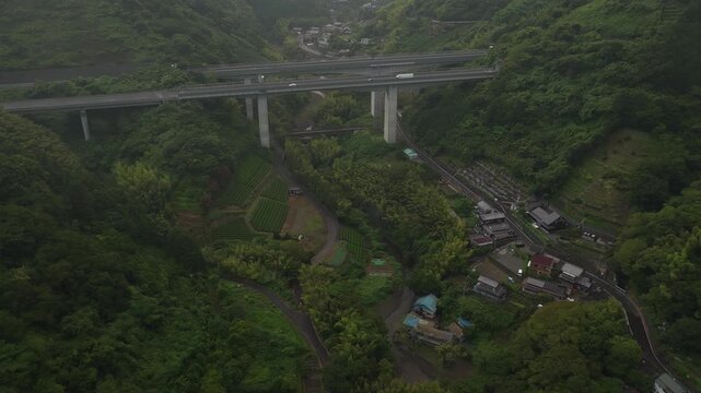 Aerial drone footage of expressway viaduct over mountain valley in Shizuoka, Japan