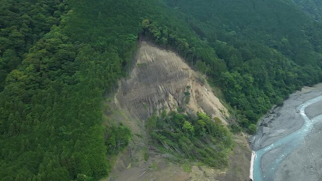 Aerial drone footage of landslide on mountain slope along Abe River in Shizuoka