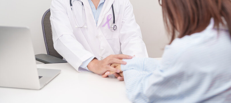doctor holding patient hand to comfort and support with empathy. light purple ribbon for concept of All cancer, April Esophageal Cancer, November gastric and Stomach cancer, and World cancer day