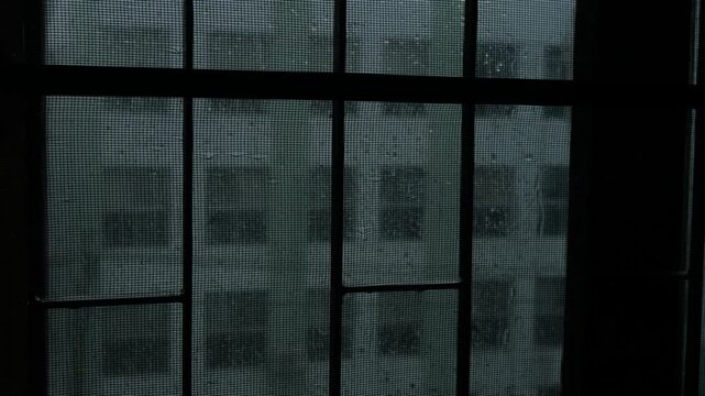 Melancholic Rainy Day Rain Drops Streaming Down Window Glass with Blurred City Buildings, Lonely Sad Moody Urban Monsoon Mood 