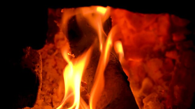 Close-up of Bright Orange Flames Burning on Wood Logs in Fireplace
