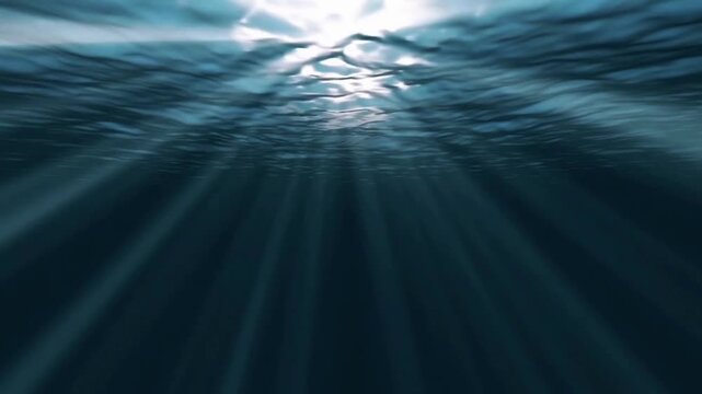 Sunlight piercing the surface of the deep blue sea gently rippling creates an atmosphere that is peaceful, mysterious, and captivating all at once.