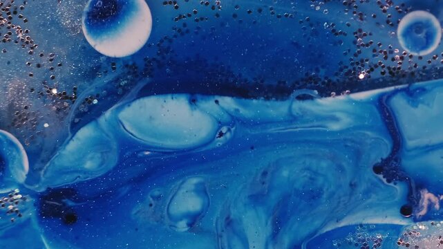 Paint fluid. Oil ink bubbles. Defocused blue white color water sequins vibrant splash round marble texture floating on abstract acrylic art background.