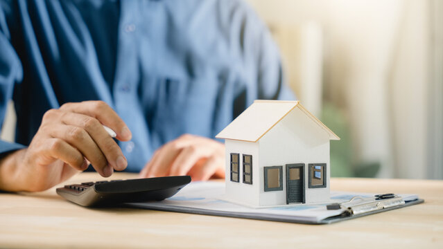 Mortgage loan interest rate payment signing real estate model planning property investment details involve person using calculator for bank home finance purchase budget analysis data
