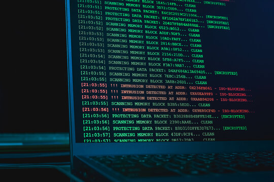 Laptop screen displaying cyber intrusion detected alert logs in terminal interface. Concept of hacking attack, network defense failure, cyber security breach, and data firewall monitoring.