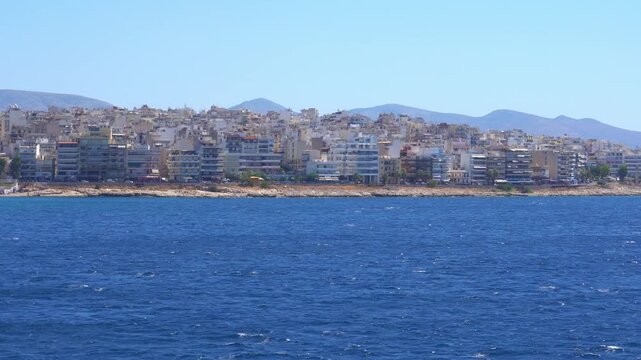 Greek cityscape view from the moving sea in slow motion