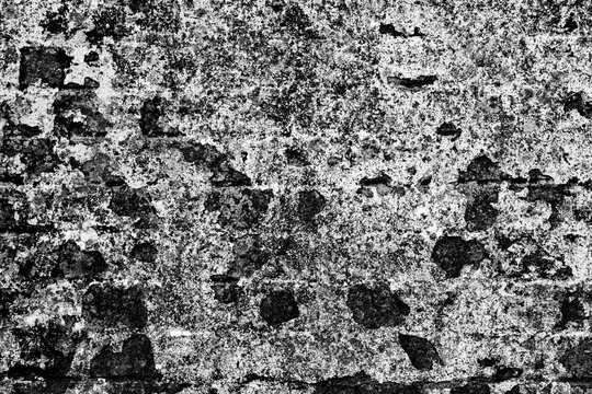 Old crumbling wall texture with peeling plaster, black and white