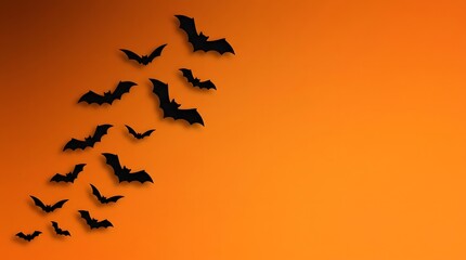 Fototapeta premium Spooky halloween bats flying on orange background perfect for october 31st party decorations seasonal designs