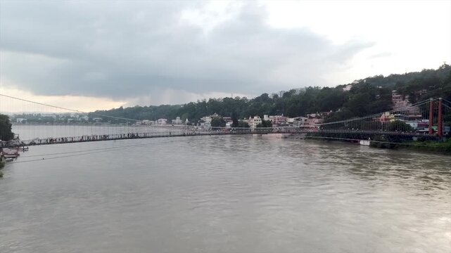 Panoramic view of Laxman Jhula suspension bridge over Ganges river in Rishikesh India.