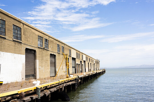 Historic Pier Warehouse on San Francisco Waterfront Under Blue Sky