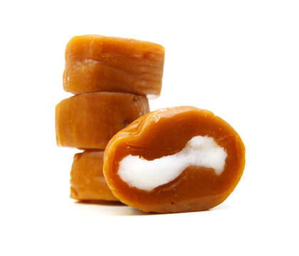 Caramel candies isolated on white background