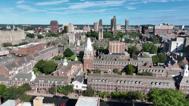 Aerial view of Yale University campus and New Haven skyline on a bright summer day with blue sky and white clouds.