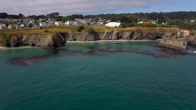 See aerial views of Mendocinos rugged coastline and the music festival tent during a sunny day along the California coast