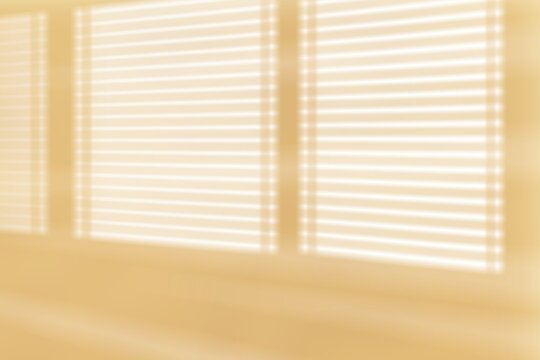  Abstract aesthetic background featuring soft sunlight streaming through horizontal window blinds, casting geometric light and shadows on a warm, minimalist beige studio wall.