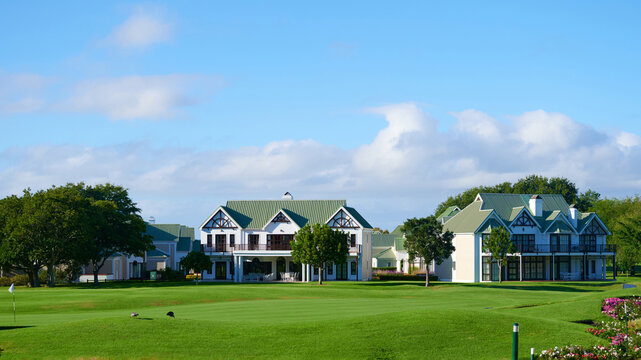 Buildings on golf course under blue sky during daytime