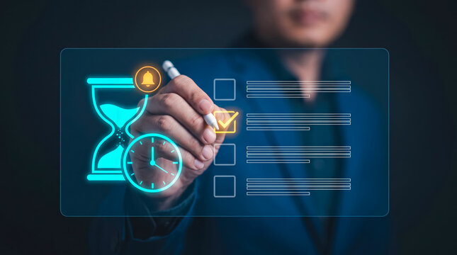 Professional using stylus to interact with holographic time management interface with alerts and clock icons