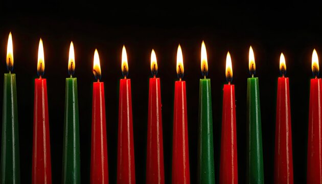 Festive Kwanzaa Candles: Red and Green Lit Against Dark Background for Holiday Celebration