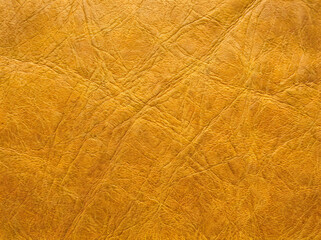 Fototapeta premium Yellow leather texture background with cross pattern