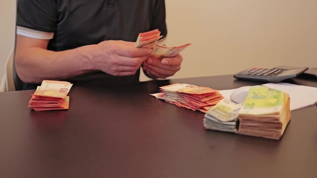Cash handling and bundled euro notes illustrate hidden economic flows