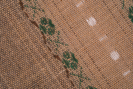 Burlap fabric with green pattern and white accents