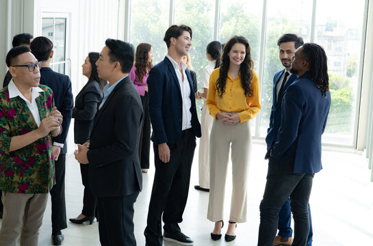Multicultural business professionals networking during corporate event in office, diverse entrepreneur group discussing partnership, collaboration and career opportunity. Teamwork and communication.