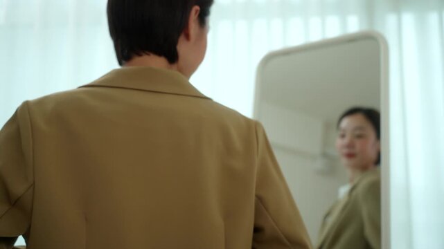 Professional woman putting on her coat before leaving for work. Morning routine business lifestyle. Hybrid work, career confidence. Work-life balance and modern professional concept.

