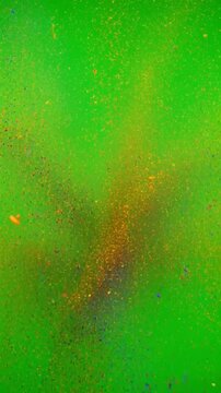 Colorful powder explosion on a green screen background