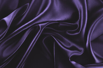 Fototapeta premium Deep purple silk fabric background with smooth folds