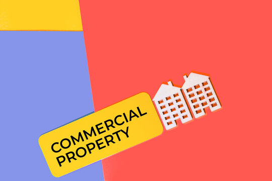 Commercial property concept with miniature buildings and text