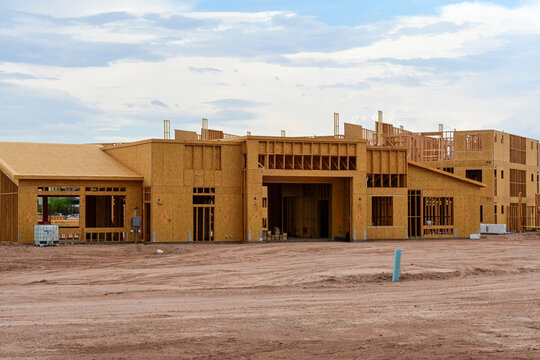 Apartment complex main building under construction with wood framing, illustrating multifamily residential development, commercial construction, and the homebuilding industry