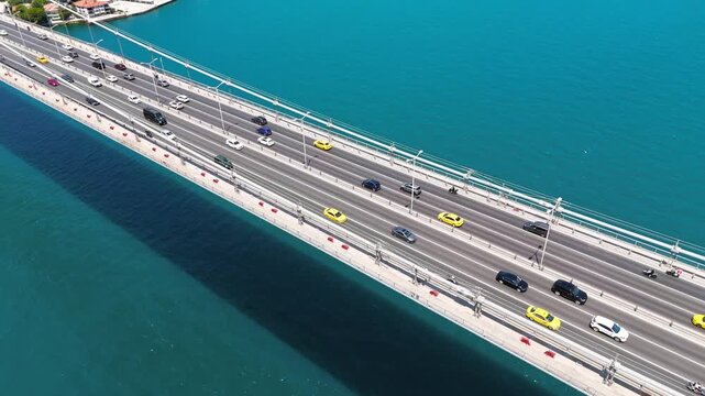 Istanbul, Turkey. The 15 July Martyrs Bridge, a steel suspension span crossing the vivid turquoise Bosphorus Strait, aerial view on a clear summer day. Aerial View, Departure of the camera