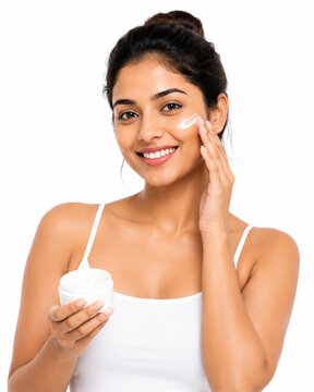 woman applying cream on her face