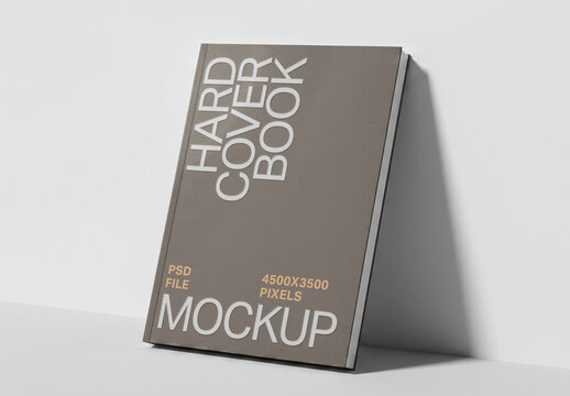 Hardcover Book Mockup Leaning Against Wall in Perspective View for Cover Presentation