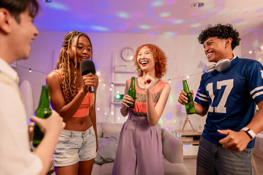 Group of diverse Generation Z friends enjoying a party in a cozy house. 