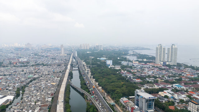 Aerial View of Coastal City Highway Traffic and Urban Contrast