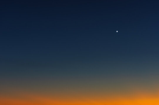 Bright Venus visible in the western sky at dusk, photographed from California.