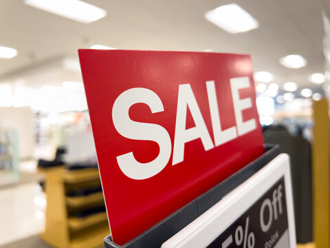Red sale sign in retail store interior