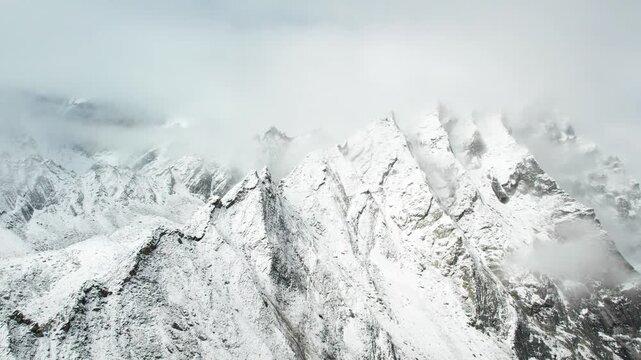 Drone view of beautiful snow covered mountains, close up view of Ama Drime Snow Mountai in Dingjie, Shigatse, Tibet, China. Travel concept 4k real time footage aerial view.