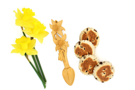 Daffodil flower love spoon and flowers, St Davids Day national Cymru symbol of pride, welsh cakes on white background. Iconic symbols of Wales.