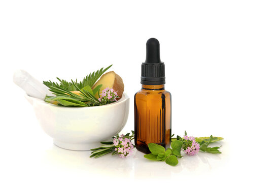 Homemade medication for Summer hayfever sneezing, itching allergies with tincture bottle, mortar, ginger spice, thyme, sage, marjoram herbs. On white antihistamine herbs.