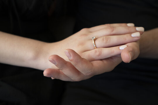 Hands with an engagement ring showcasing love and commitment, perfect for romantic themes or wedding-related projects.