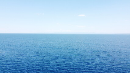 Fototapeta premium Aerial drone view of turquoise and deep blue ocean water gradient under clear blue sky