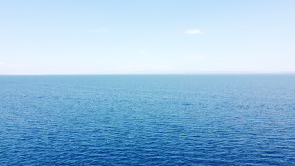 Fototapeta premium Aerial drone view of turquoise and deep blue ocean water gradient under clear blue sky